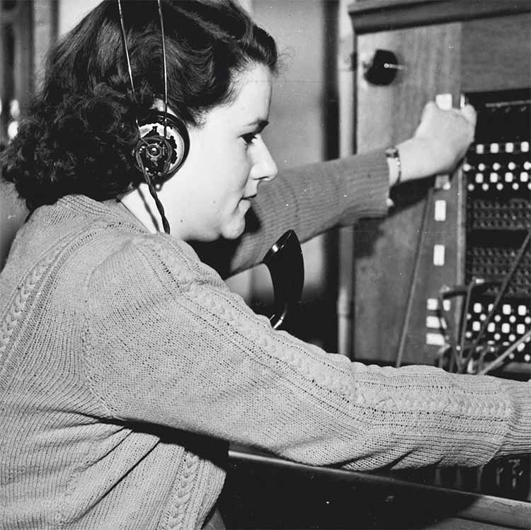 historical photo of a woman manning a switchboard